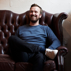 Image of Matt Studdert sitting in a chair smiling